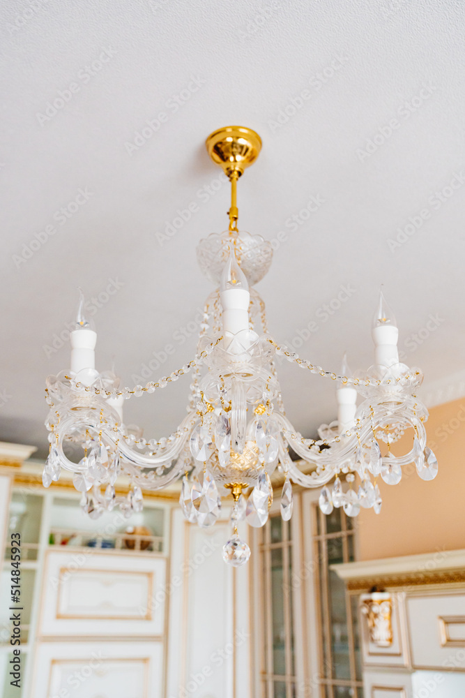 Beautiful classic crystal ceiling lamp on the ceiling of the apartment. Beautiful classic crystal ceiling lamp on the ceiling of the apartment.