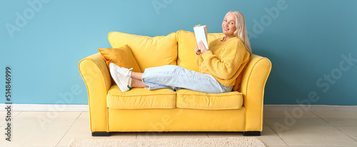 Happy mature woman reading ...