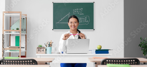 Asian female teacher with l...
