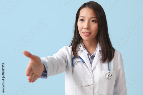 Female Asian doctor giving ...