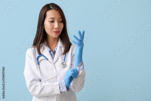 Female Asian doctor putting...