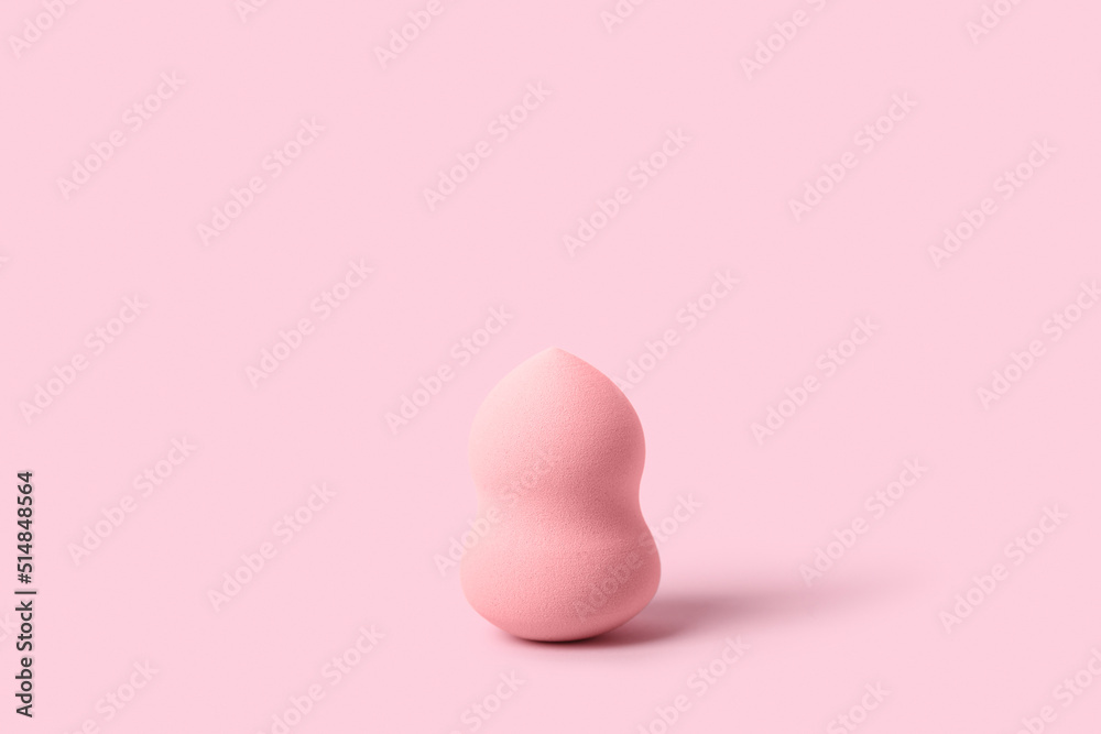 Fototapeta premium Makeup sponge on pink background