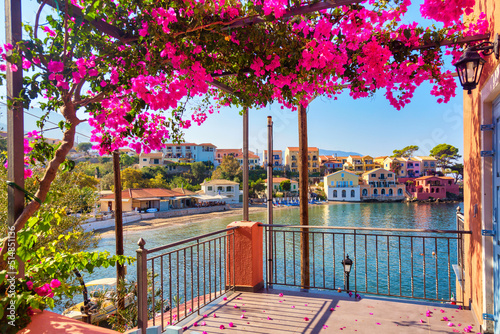 Colorful houses view from balcony with bougainvillea flowers in Assos village on Kefalonia Island, Greece photo