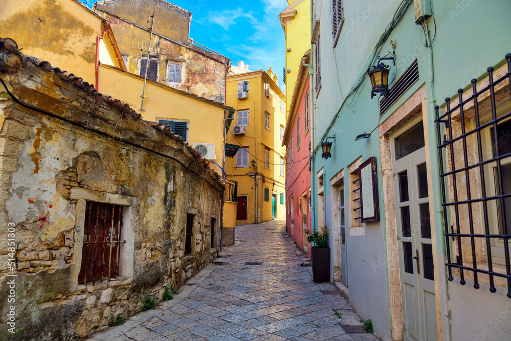Kerkyra city narrow street view with colorful houses during sunny day. Corfu Island, Ionian Sea, Greece.