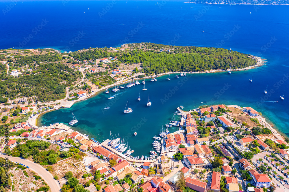 Aerial drone view of Fiscardo village port with luxury boats and yachts on Kefalonia island, Greece.
