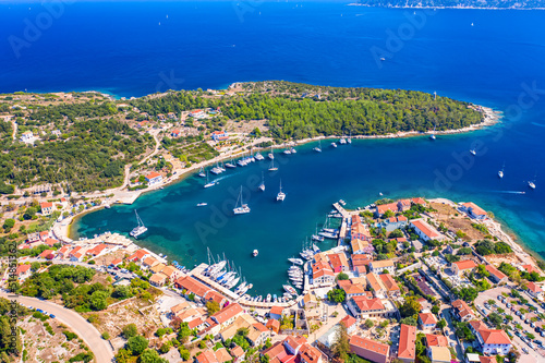 Aerial drone view of Fiscardo village port with luxury boats and yachts on Kefalonia island, Greece.