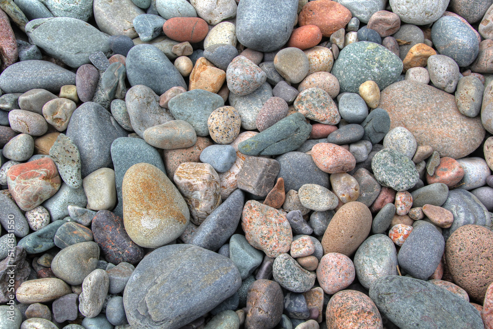 Beach rounded rocks in various colors from ocean Beach rounded rocks in various colors from ocean