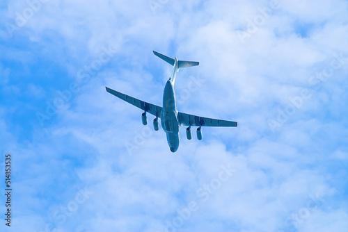 Airplane is flying in blue sky. Commercial passenger and cargo a