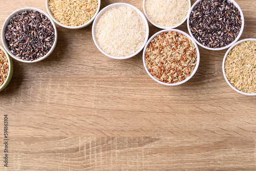 Thai rice seed (brown, white and purple) in bowl on wooden background, Table top view