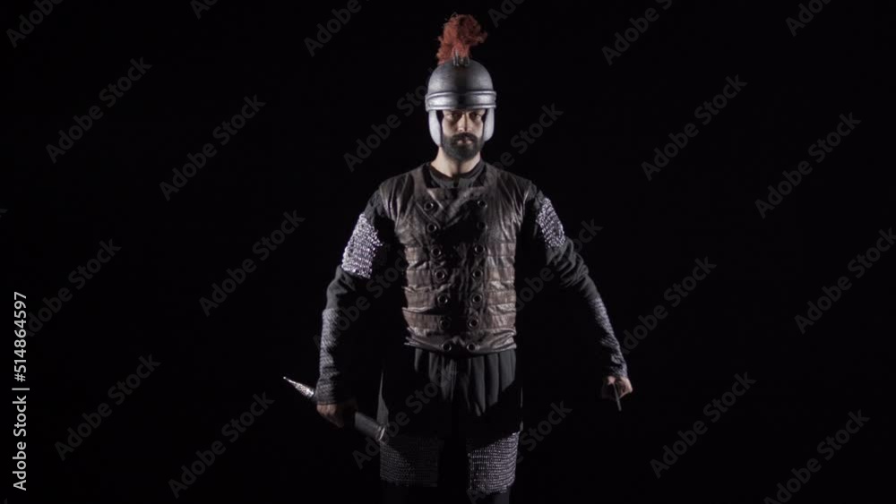 Historical Roman Soldier. Black background.
The Roman soldier looks at the camera, takes out his sword and salutes.
Historical Roman Soldier. Black background.
The Roman soldier looks at the camera, takes out his sword and salutes.