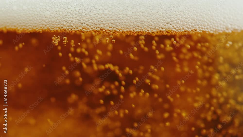 Foamy beer in glass close-up texture. Alcohol golden beer drink in mug. Fresh pale ale macro. Foamy beer in glass close-up texture. Alcohol golden beer drink in mug. Fresh pale ale macro.