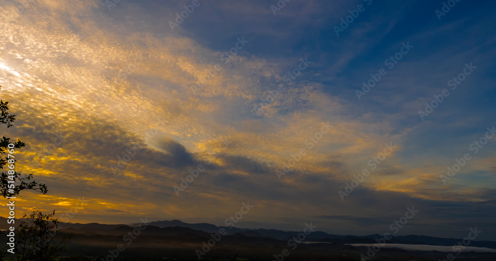 Blue golden sky sunrise dramatic beautiful landscape mountain. Dawn sky gold dusk time cloudscape with sunlight. Dramatic sunset over mountain landscape. Beautiful landscape foggy hills twilight time