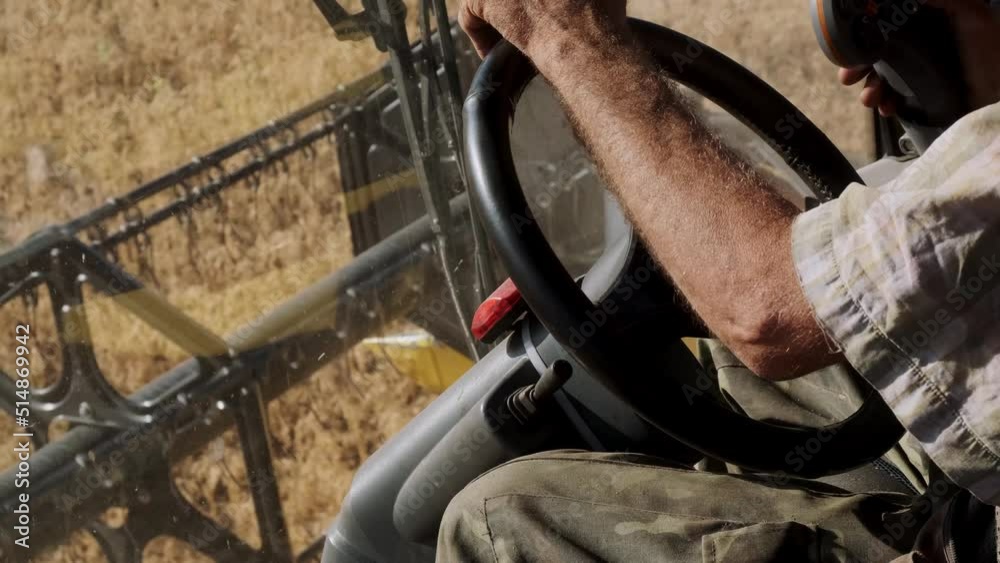Male Hands Farmer Driver On Steering Wheel Combine Harvest On Agricultural Field. View From Inside Tractor Driver Turns Steering Wheel Agricultural Machine. Prores, Slow Motion, 4k Male Hands Farmer Driver On Steering Wheel Combine Harvest On Agricultural Field. View From Inside Tractor Driver Turns Steering Wheel Agricultural Machine. Prores, Slow Motion, 4k