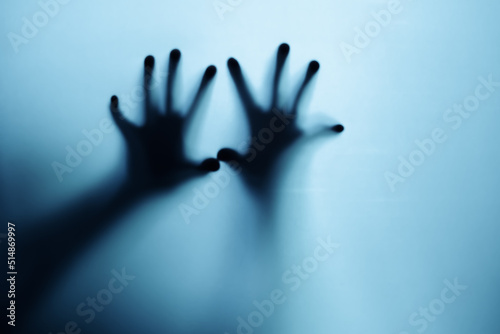 Shadow of a zombie hand on white background.