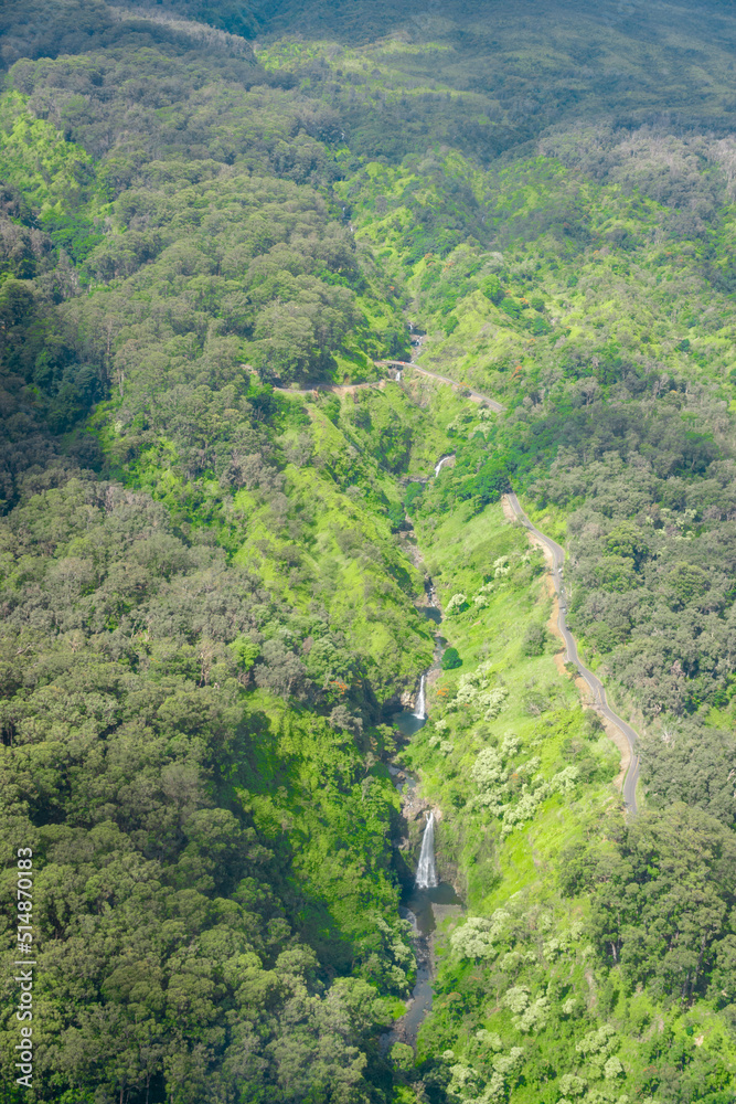 An aerial view of a waterfall in the Hana Rainforest on the island of Maui, Hawaii.