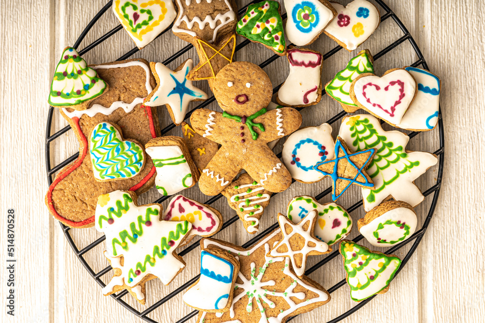 gingerbread man cookie in the middle of christmas glazed gingerbread cookies, stars, trees, hearts and boots
