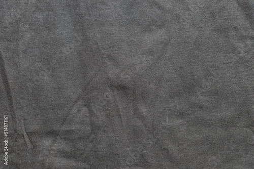 Crumpled texture of black textile clothing background