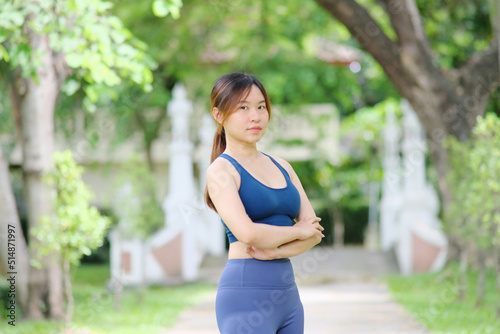 Woman exercising in a park. A young woman exercises her muscles while surrounded by the outdoors.