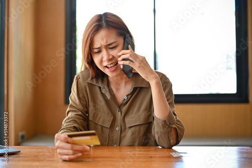 Angry and furious woman calling credit card call-centre service to complain the problems.