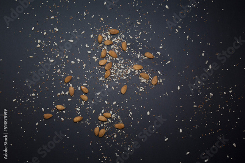 Cereal grains scattered on the black table preparing light and vegan food