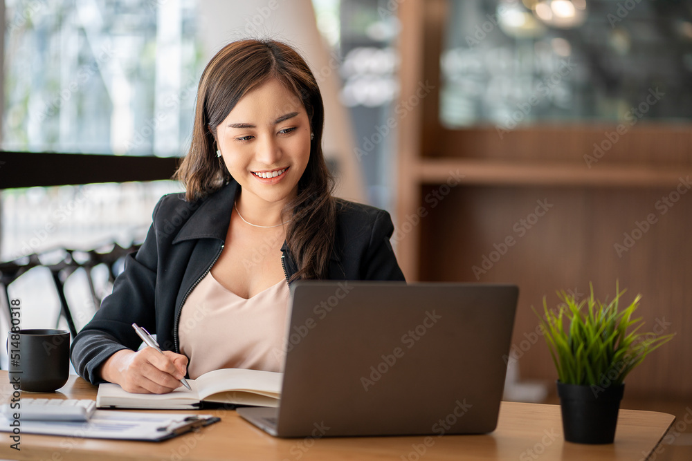 Asian businesswoman working using laptop computer in modern office Make an account analysis report with financial graphs and real estate investment data. financial and tax system concepts Asian businesswoman working using laptop computer in modern office Make an account analysis report with financial graphs and real estate investment data. financial and tax system concepts