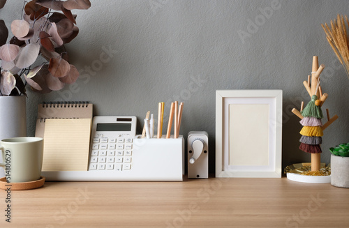 staionery stuff on working desk at home with photo frame photo