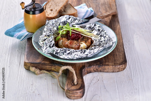 Bacon-coated grilled Camembert cheese