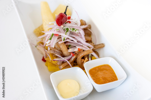 Peruvian food: pork skin in onion sarsa and 