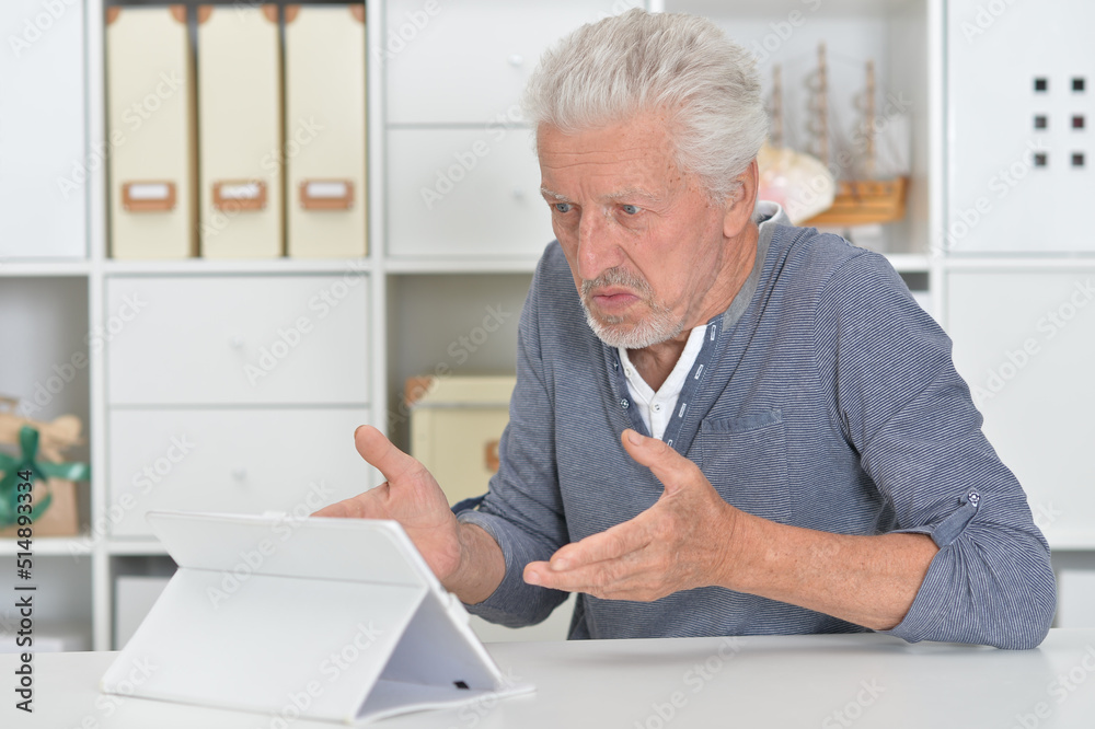 senior man with tablet computer at home senior man with tablet computer at home