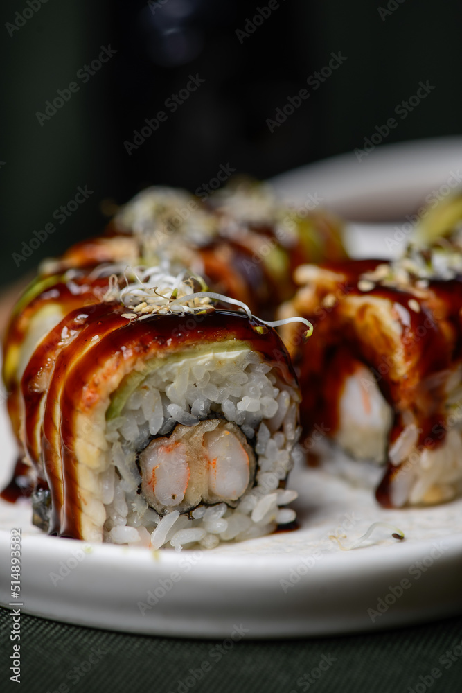 sushi roll with avocado in a white plate macro photo sushi roll with avocado in a white plate macro photo
