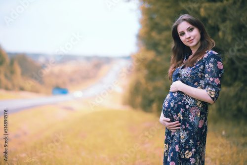 Pregnant girl in a dress in nature © alexkich
