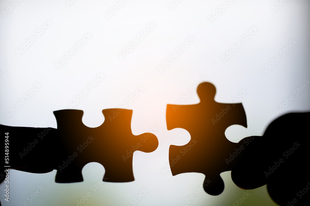Closeup hand of woman connecting jigsaw puzzle Closeup hand of woman connecting jigsaw puzzle