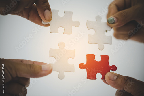 Group of business people assembling jigsaw