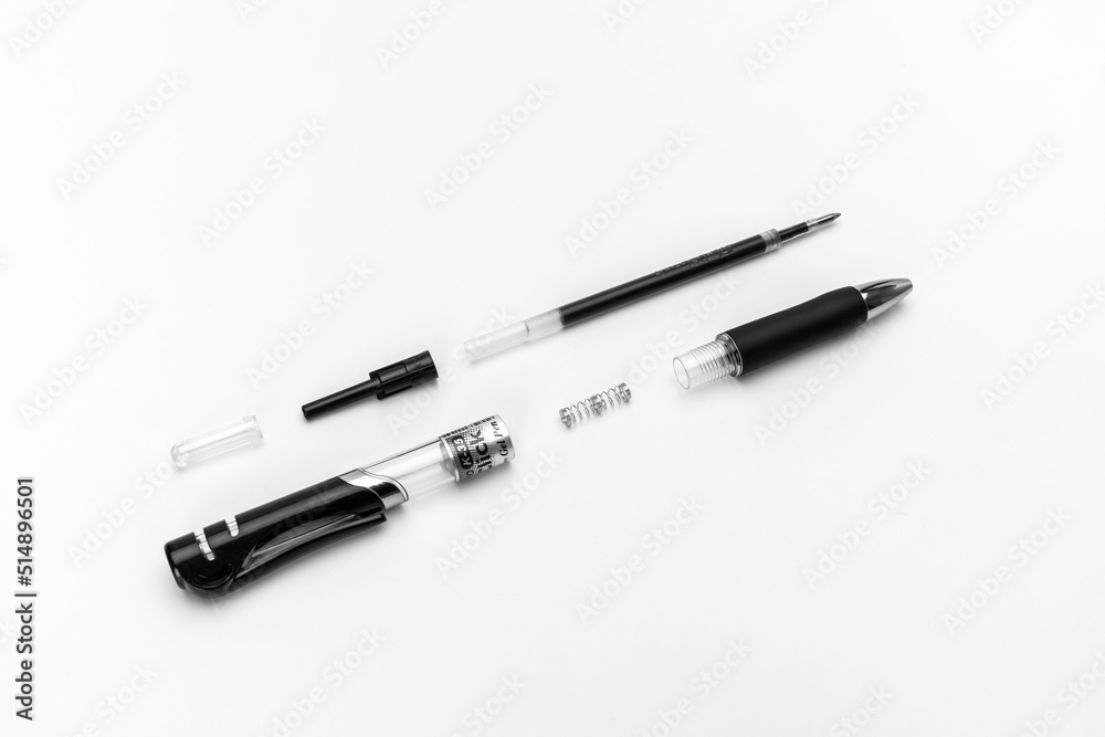 Disassembled gel automatic pen with a black gel rod on a white background Disassembled gel automatic pen with a black gel rod on a white background