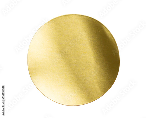 Blank golden round adhesive paper metallic sticker label isolated on white background photo