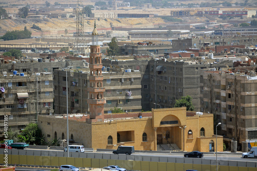 Aerial view of Cairo, Egypt from The Mokattam mountain and hills showing multiple buildings, streets, traffic, residential houses and bridges, selective focus photo