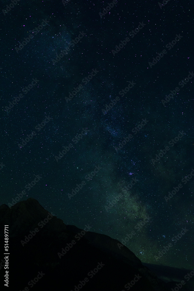Fototapeta premium nightscape, night full of stars, view at the mountain Hoher Goell, Berchtesgaden, Bavaria, Germany, and the Milkyway behind in the night sky