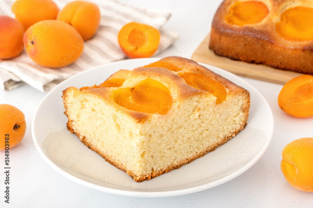 Homemade apricot cake on plate. Fluffy fruit pie with ripe apricots filling. Summer bake concept.