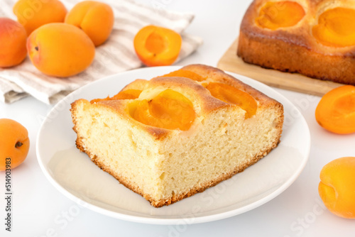 Homemade apricot cake on plate. Fluffy fruit pie with ripe apricots filling. Summer bake concept.