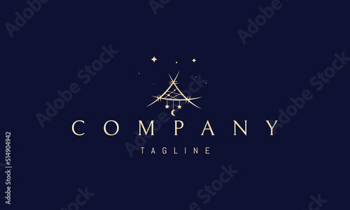 Vector golden logo on which an abstract image of a shamanic amulet with pendants.