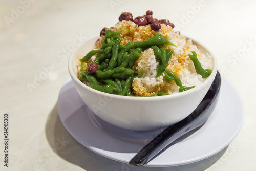 Close-up view of the cendol dessert with gula Melaka syrup. Cendol is made from crushed ice cubes, jelly, coconut milk, and red beans.