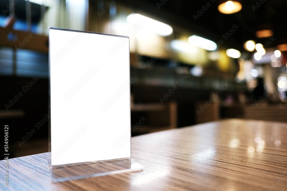 Mock up Menu frame standing on wood table in Bar restaurant cafe. space for text Mock up Menu frame standing on wood table in Bar restaurant cafe. space for text