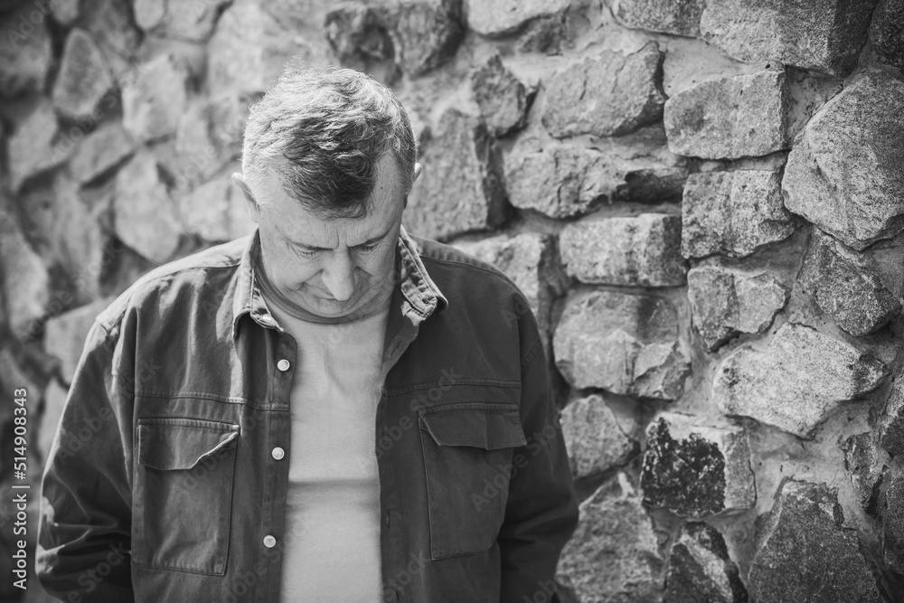 Psychology portrait of mature man, outdoor scene, concept of crisis, problems in life Psychology portrait of mature man, outdoor scene, concept of crisis, problems in life