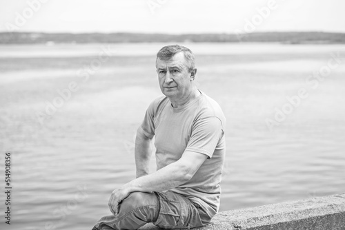 Psychology portrait of mature man, outdoor scene, concept of crisis, problems in life