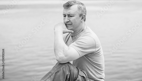 Psychology portrait of mature man, outdoor scene, concept of crisis, problems in life