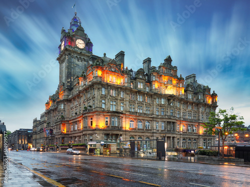 Edinburgh at night scene with Lights on Princess street and Balmoral hotel on background photo