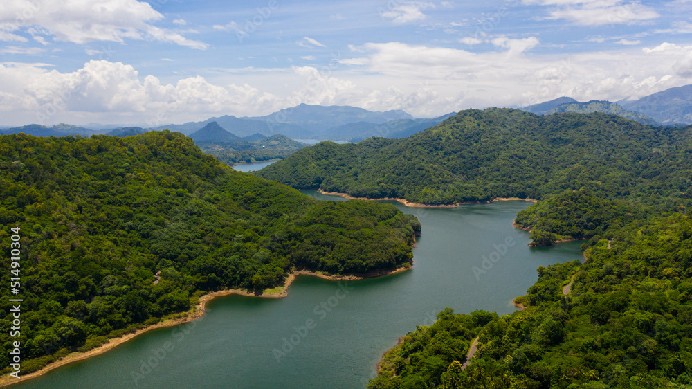 Tropical landscape: A mountain lake among beautiful mountains with forest. Victoria Reservoir, Sri Lanka.