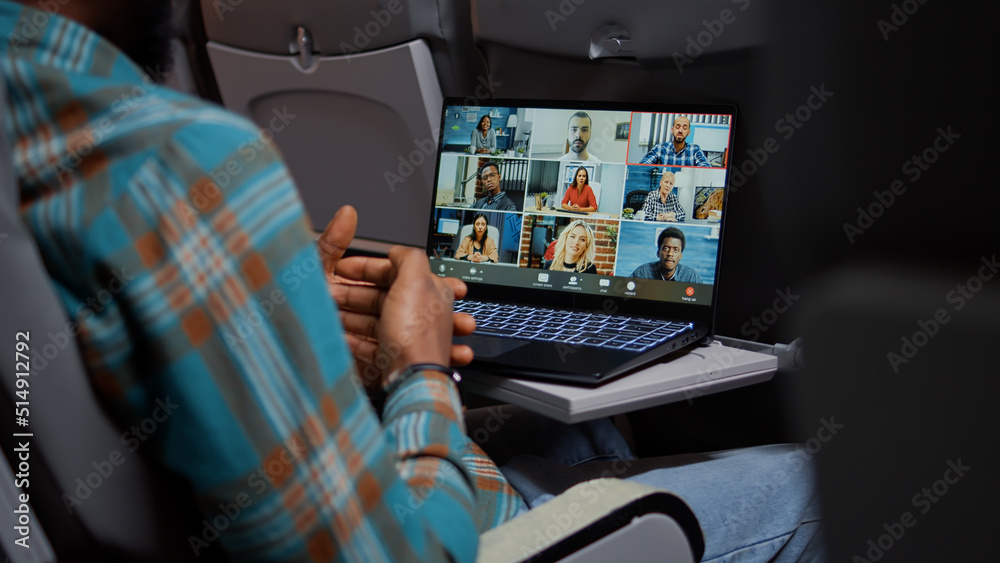 Entrepreneur in airplane attending online videocall meeting with people on remote teleconference chat. Internet telecommunication with videoconference call and webcam. Close up. - obrazy, fototapety, plakaty 