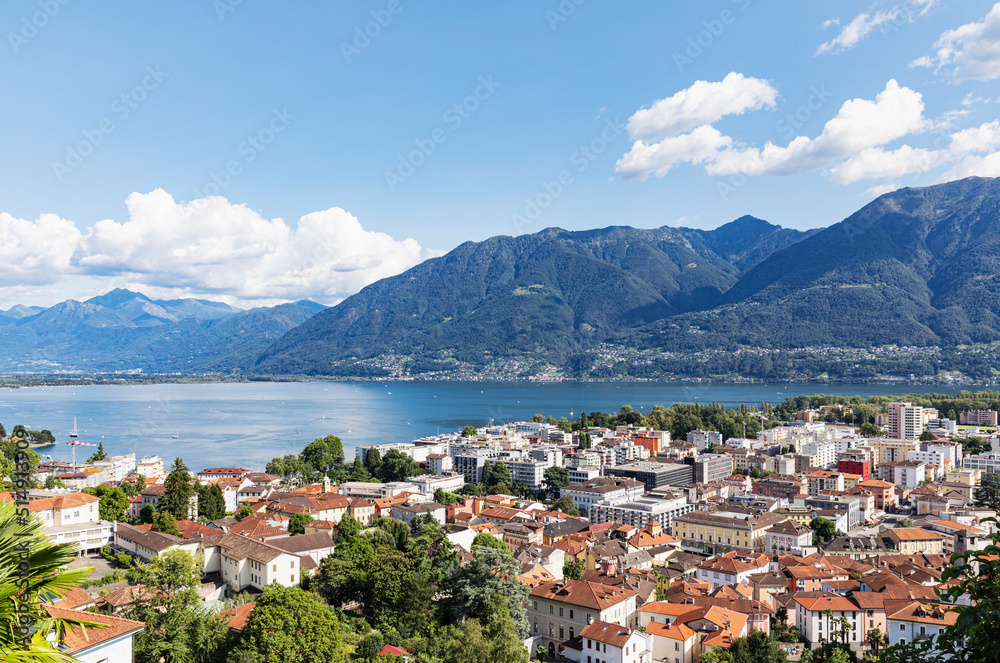 Switzerland, Ticino, Locarno, City houses with Lake Maggiore and surrounding mountains in background Switzerland, Ticino, Locarno, City houses with Lake Maggiore and surrounding mountains in background