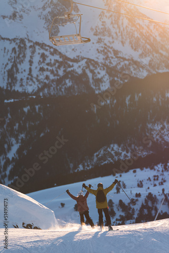 Couple enjoying skiing at Baqueira Beret resort on vacation, Pyrenees, Spain photo